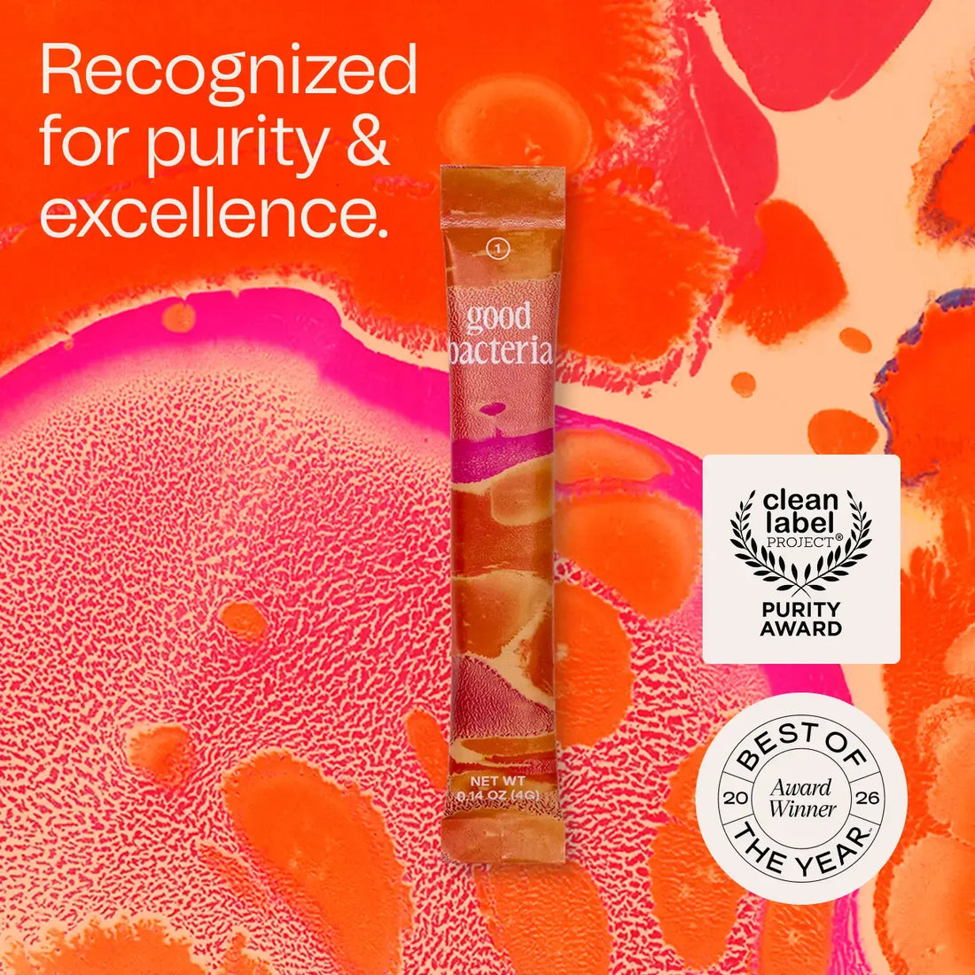 A single Good Bacteria probiotic stick pack is centered on a vivid abstract orange and pink background with marketing text reading 'Recognized for purity & excellence.' and award badges for Clean Label Purity Award and Best of the Year.
